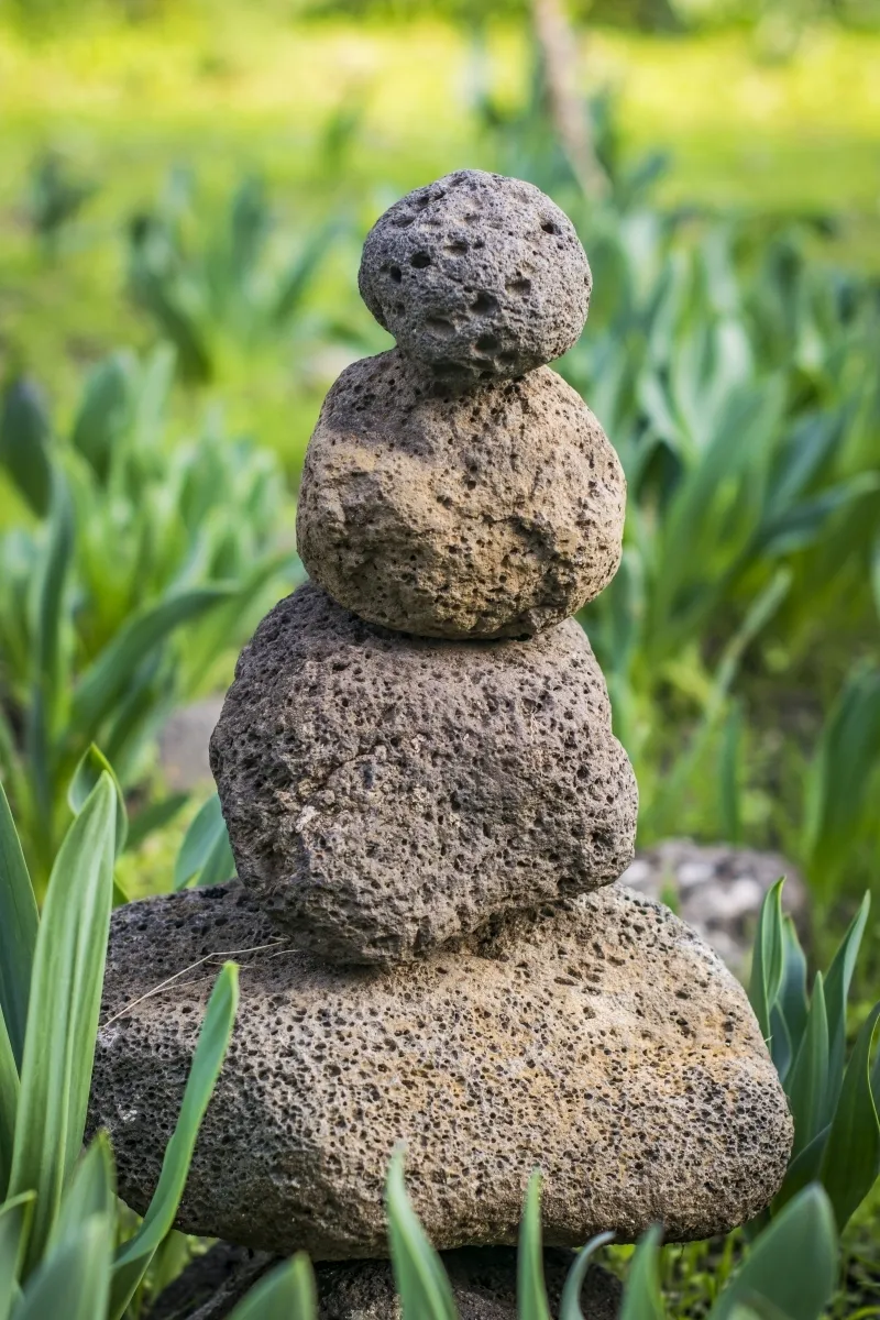 Small cairn of rounded stones in the grass